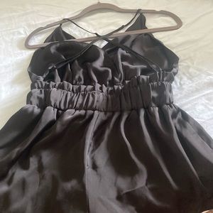 Black, low-back romper. Never worn. Plunging neckline.